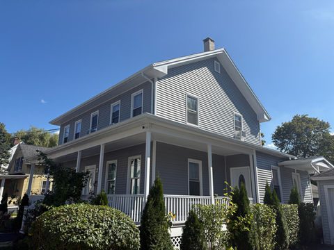Completed gray siding on a colonial home